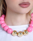 Collana girocollo in acrilico con sfere rosa di cui tre placcate in oro - Mya Accessories