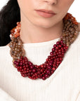 Collana girocollo a treccia con sfere in acrilico sui toni rossi ed arancio - Mya Accessories