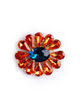 Spilla in metallo a forma di fiore con pietre in vetro arancio e blu - Mya Accessories