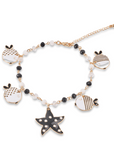 Bracciale con Charm Stella Marina e Pesce Palla in Metallo color Oro - Bianco e Nero - Mya Accessories